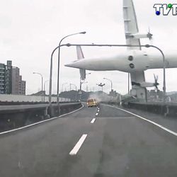 This image taken from video provided by TVBS shows a commercial airplane clipping an elevated roadway just before it careened into a river in Taipei, Taiwan, Wednesday, Feb. 4, 2015. The ATR-72 prop-jet aircraft had 58 people aboard.