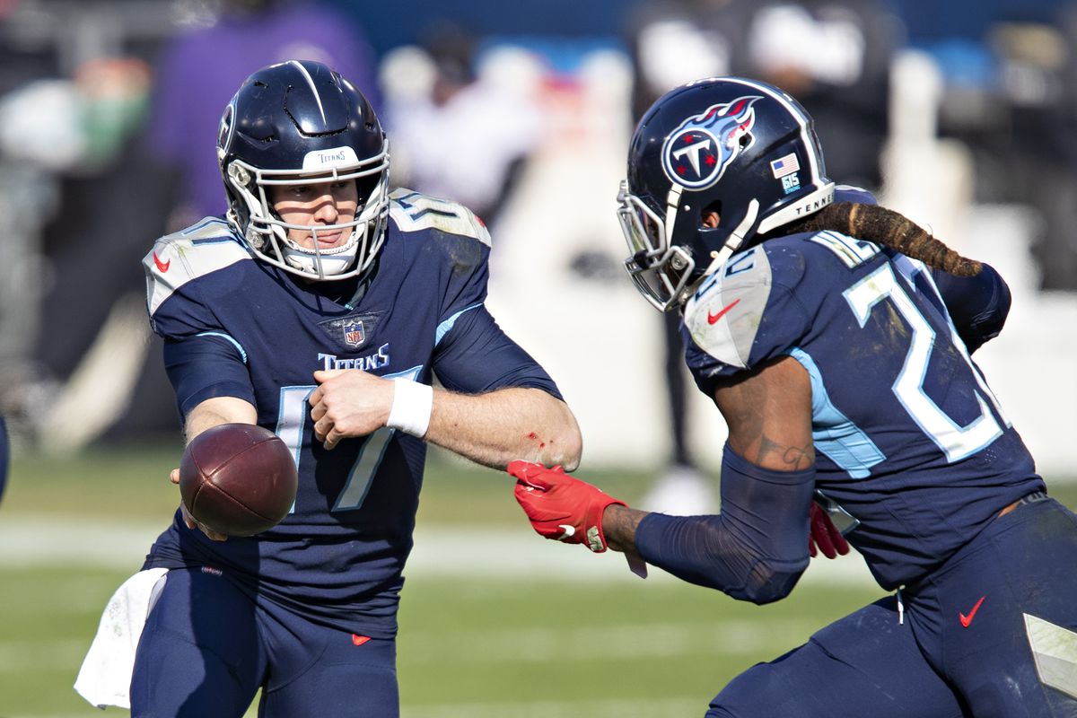 Quarterback Ryan Tannehill #17 hands off the ball to running back Derrick Henry #22 of the Tennessee Titans during their AFC Wild Card Playoff game against the Baltimore Ravens at Nissan Stadium on January 10, 2021 in Nashville, Tennessee. The Ravens defeated the Titans 20-13.