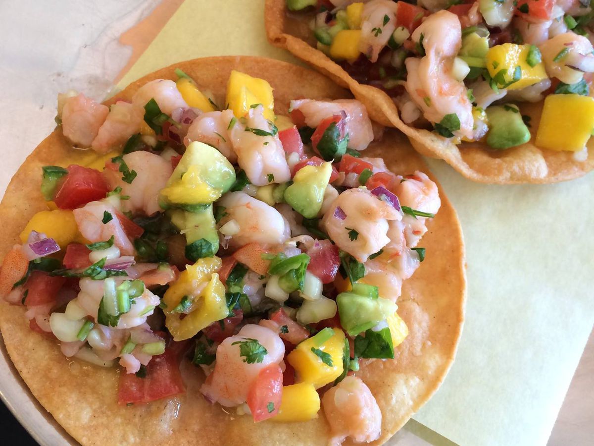 Two corn tortillas with seafood