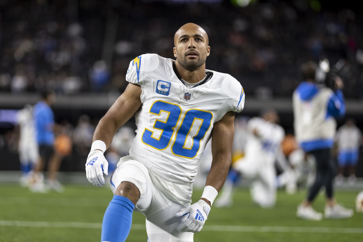 Austin Ekeler of the Los Angeles Chargers stretches as he warms up prior to an NFL football game between the Las Vegas Raiders and the Los Angeles Chargers at Allegiant Stadium on December 14, 2023 in Las Vegas, Nevada.