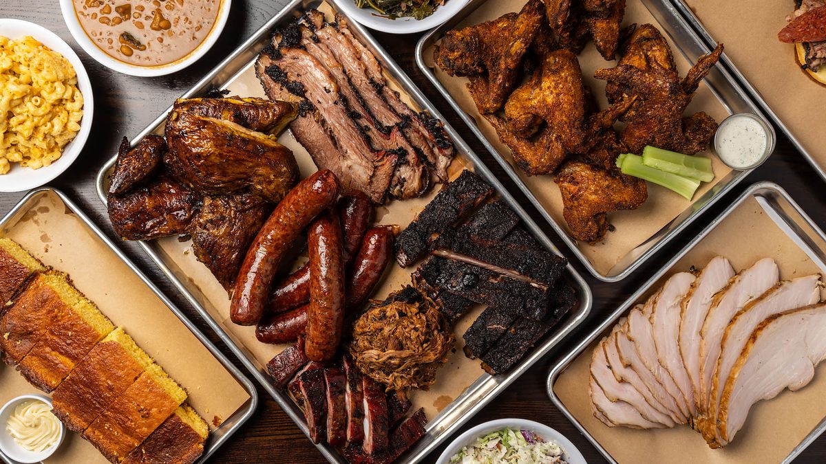 An assortment of barbecued ribs, chicken, links, smoked turkey, and side dishes at Bludso’s BBQ.