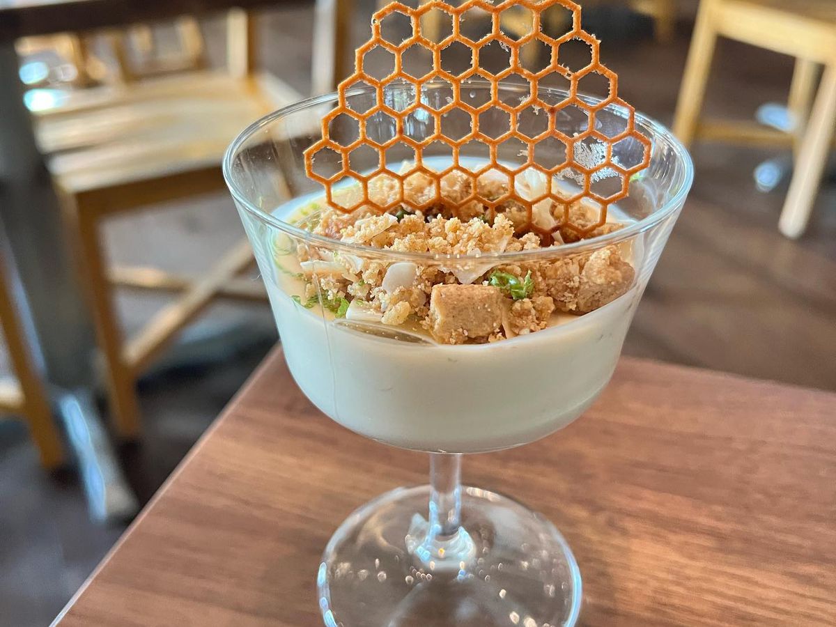 The tropical fruit posset at Foundation Social Eatery in Alpharetta with coconut-lime custard crowned with a lemongrass and lime leaf gel sprinkled with salted graham cracker crumble garnished with a honey tuille.