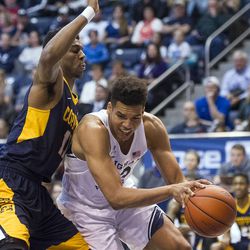 Brigham Young forward Yoeli Childs (23) works down low against Coppin State forward Izais Hicks (11) during an NCAA college basketball game in Provo on Thursday, Nov. 17, 2016.