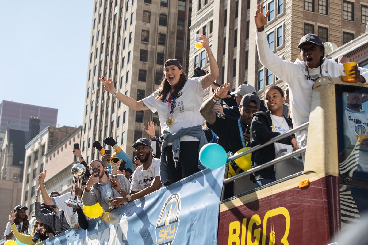 The Chicago Sky team waves to fans along South Michigan Avenue during the celebration of their WNBA championship in the Loop, Tuesday.