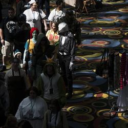People parade through the Salt Palace Convention Center at the kickoff of the Salt Lake Comic Con in Salt Lake City, Thursday, Sept. 4, 2014.