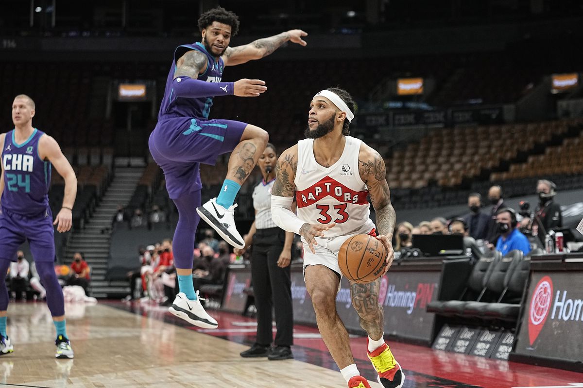 Toronto Raptors guard Gary Trent Jr. (33) dribbles the ball past Charlotte Hornets forward Miles Bridges (0) during the second half at Scotiabank Arena.