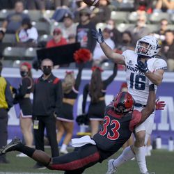 Utah State wide receiver Brandon Bowling (16) catches a touchdown pass while San Diego State safety Patrick McMorris (33) tackles him in the second half during an NCAA college football game for the Mountain West Conference Championship, Saturday, Dec. 4, 2021, in Carson, Calif. 