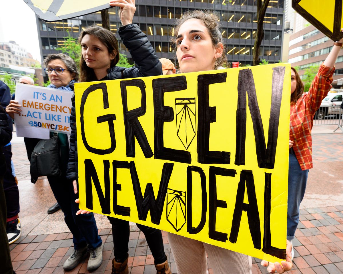 A protester holding a placard during the Sunrise NYC-organized rally in support of the Green New Deal outside Senator Chuck Schumer’s (D-NY) New York City office, April 30, 2020