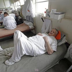 Inmate John Morrell rests on his bed in the geriatric unit during a media tour Thursday, Feb. 26, 2015, at the Utah State Prison in Draper. Gov. Gary Herbert said Thursday that he's opposed to the idea of allowing a state commission to pick a location to build a new prison instead of leaving the decision with the Legislature. 