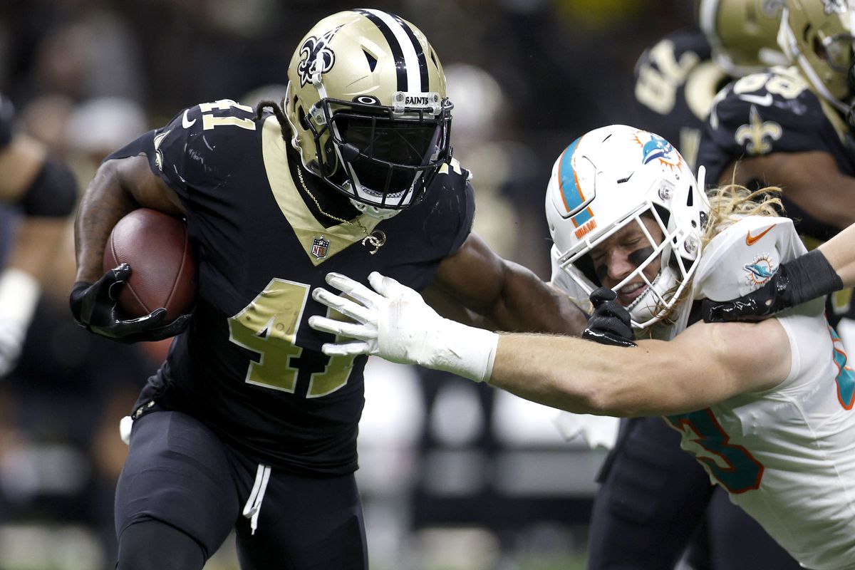 Alvin Kamara #41 of the New Orleans Saints evades a tackle by Andrew Van Ginkel #43 of the Miami Dolphins in the third quarter of the game at Caesars Superdome on December 27, 2021 in New Orleans, Louisiana.