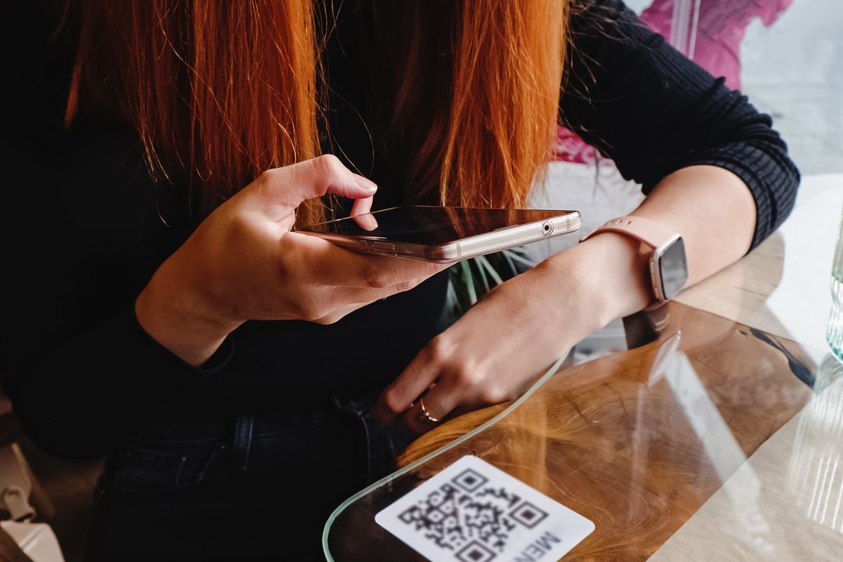 A person scanning a QR code with mobile phone