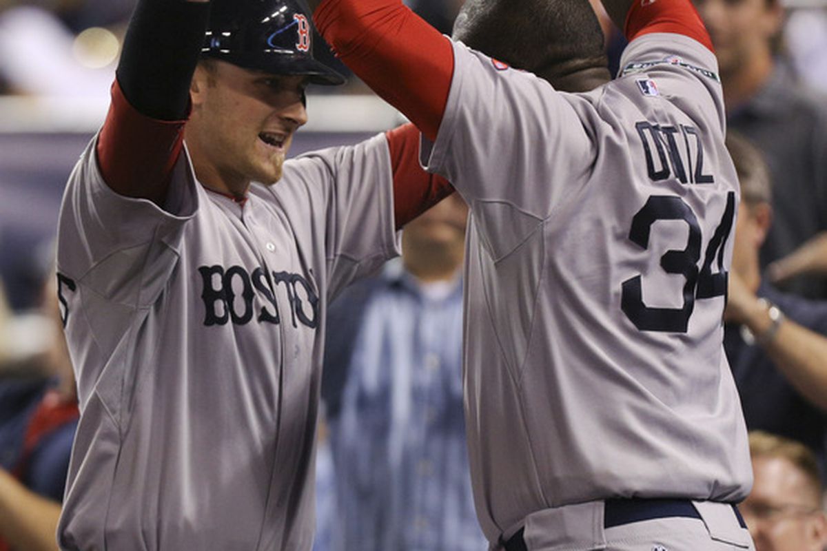 KANSAS CITY, MO:  Will Middlebrooks #64 of the Boston Red Sox celebrates his two-run home run with David Ortiz #34 during a game against the Kansas City Royals at Kauffman Stadium in Kansas City, Missouri. (Photo by Ed Zurga/Getty Images)