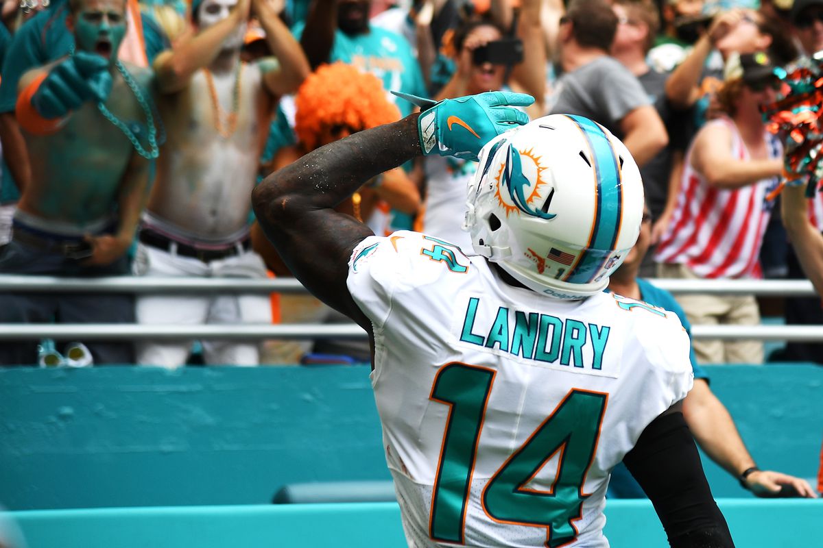 MIAMI GARDENS, FL:  Miami Dolphins wide receiver Jarvis Landry (14) salutes the crowd after scoring a touchdown against the New York Jets defense at Hard Rock Stadium.
