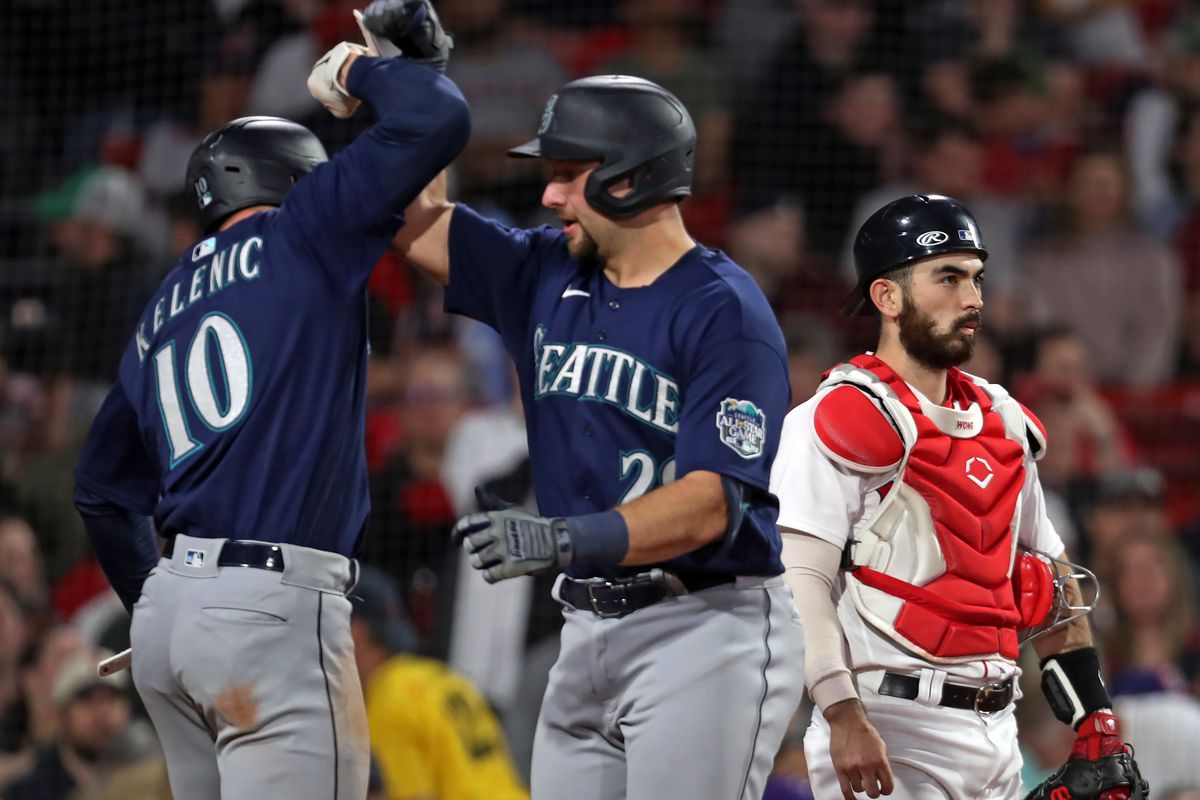 Seattle Mariners C Cal Raleigh is greeted at home plate by teammate Jarred Kelenic after hitting a home run in the sixth inning. The Mariners beat the Boston Red Sox, 10-1.