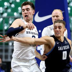 Brigham Young Cougars guard Zac Seljaas (2) battles San Diego Toreros forward Isaiah Pineiro (0) for the ball as the BYU Cougars and San Diego Toreros play in WCC tournament action at the Orleans Arena in Las Vegas on Saturday, March 9, 2019. San Diego won 80-57.