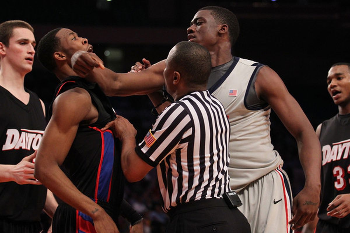 NEW YORK - MARCH 30:  Reginald Buckner #2 of Ole Miss hits Chris Johnson #4 of the Dayton Flyers in the face during their semi final at Madison Square Garden on March 30, 2010 in New York, New York.  (Photo by Nick Laham/Getty Images)