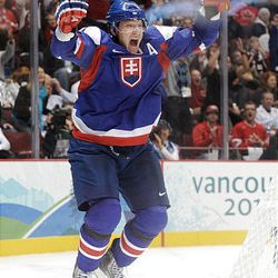 Marian Hossa of Slovakia celebrates after scoring a goal past Miikka Kiprusoff of Finland in the second period during the men's ice hockey bronze-medal game at Canada Hockey Place Saturday.