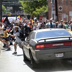 A vehicle drives into a group of protesters demonstrating against a white nationalist rally in Charlottesville, Va., Saturday, Aug. 12, 2017. The nationalists were holding the rally to protest plans by the city of Charlottesville to remove a statue of Confederate Gen. Robert E. Lee. There were several hundred protesters marching in a long line when the car drove into a group of them.