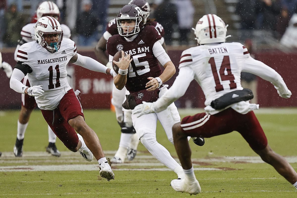 Conner Weigman #15 of the Texas A&amp;M Aggies with a quarterback keeper against the Massachusetts Minutemen at Kyle Field on November 19, 2022 in College Station, Texas.