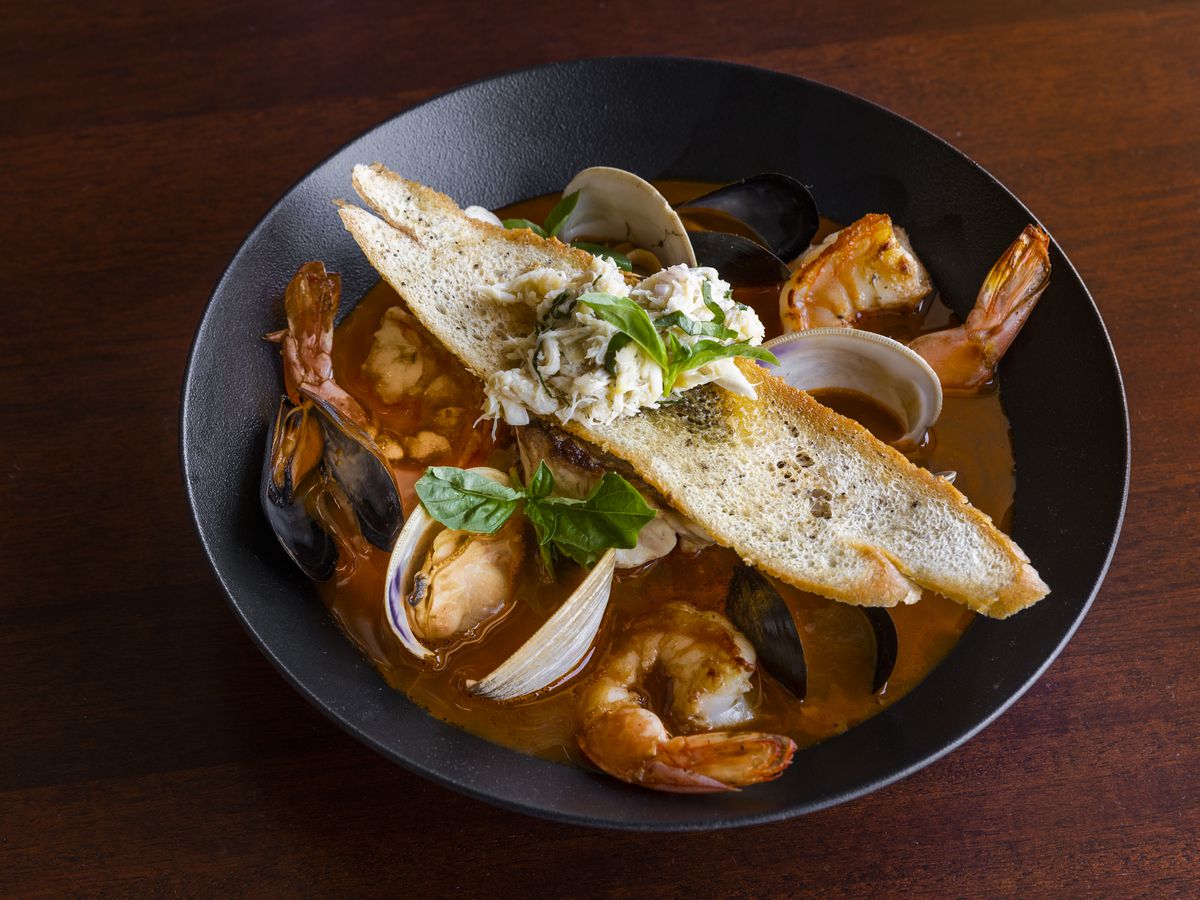 Gulf Cioppino topped with toasted bread.