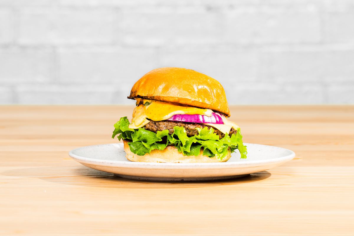 cheeseburger on plate, on wooden tables