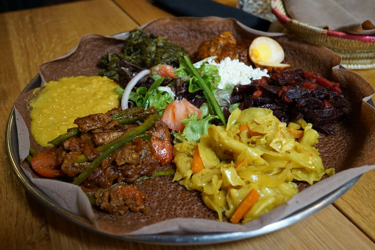 The “chef’s selection” messob is served with injera bread at Demera restaurant in Uptown.