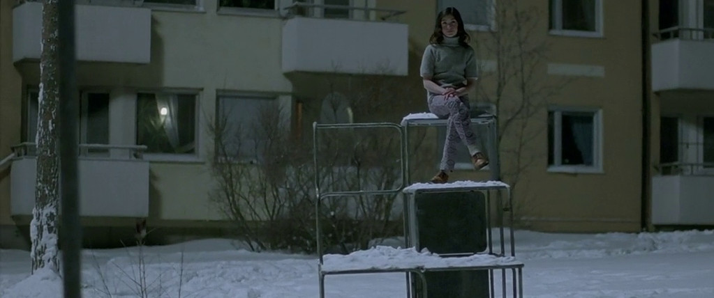 Lina Leandersson sits atop a frozen sculpture in Let the Right One In.
