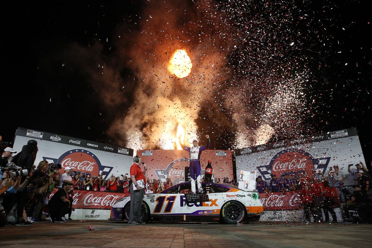 Denny Hamlin, driver of the #11 FedEx Ground Toyota, celebrates in Victory Lane after winning the NASCAR Cup Series Coca-Cola 600 at Charlotte Motor Speedway on May 29, 2022 in Concord, North Carolina.