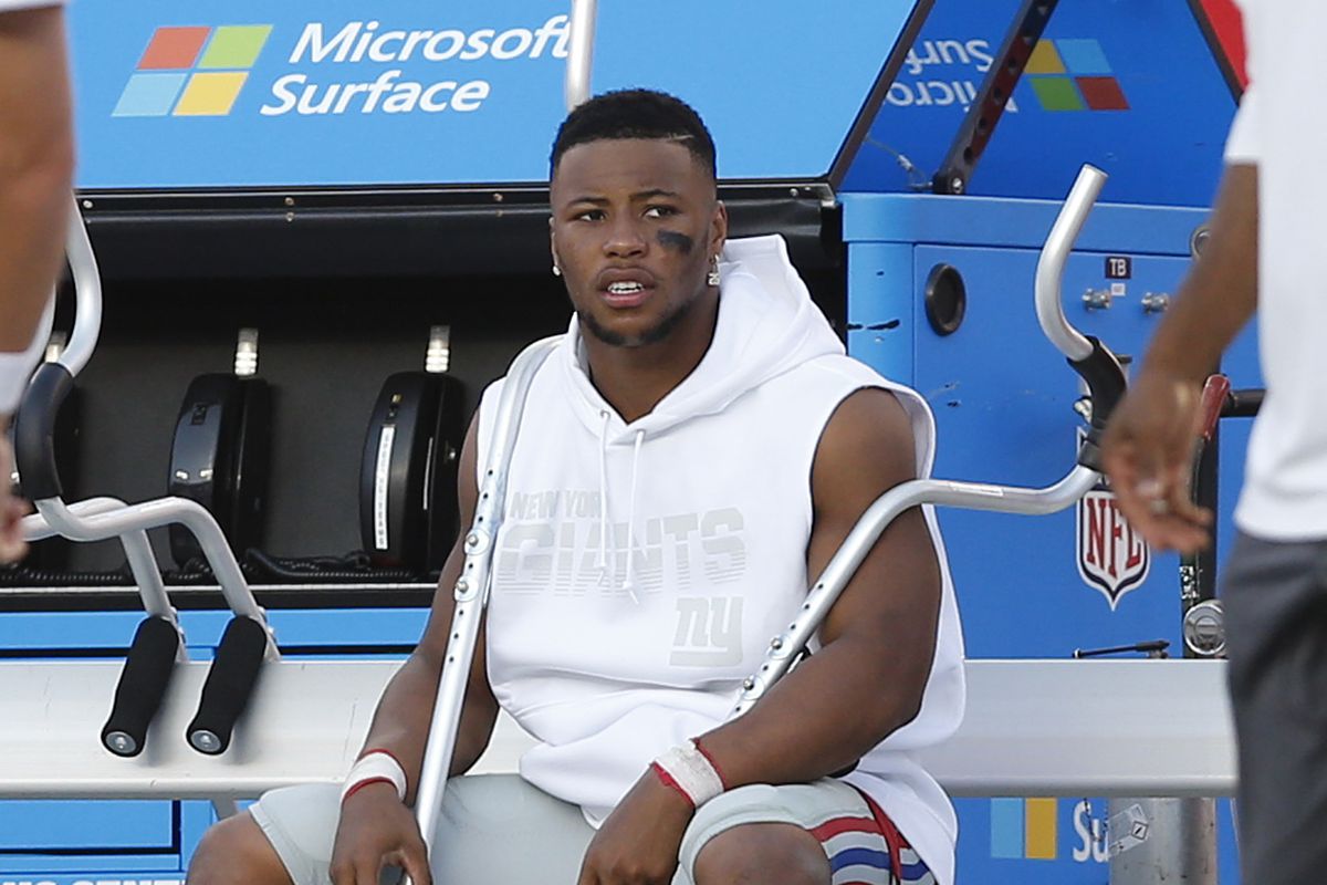Running back Saquon Barkley of the New York Giants sits on the bench with crutches and a boot after injuring his ankle in the first half during the game against the Tampa Bay Buccaneers at Raymond James Stadium on September 22, 2019 in Tampa, Florida.