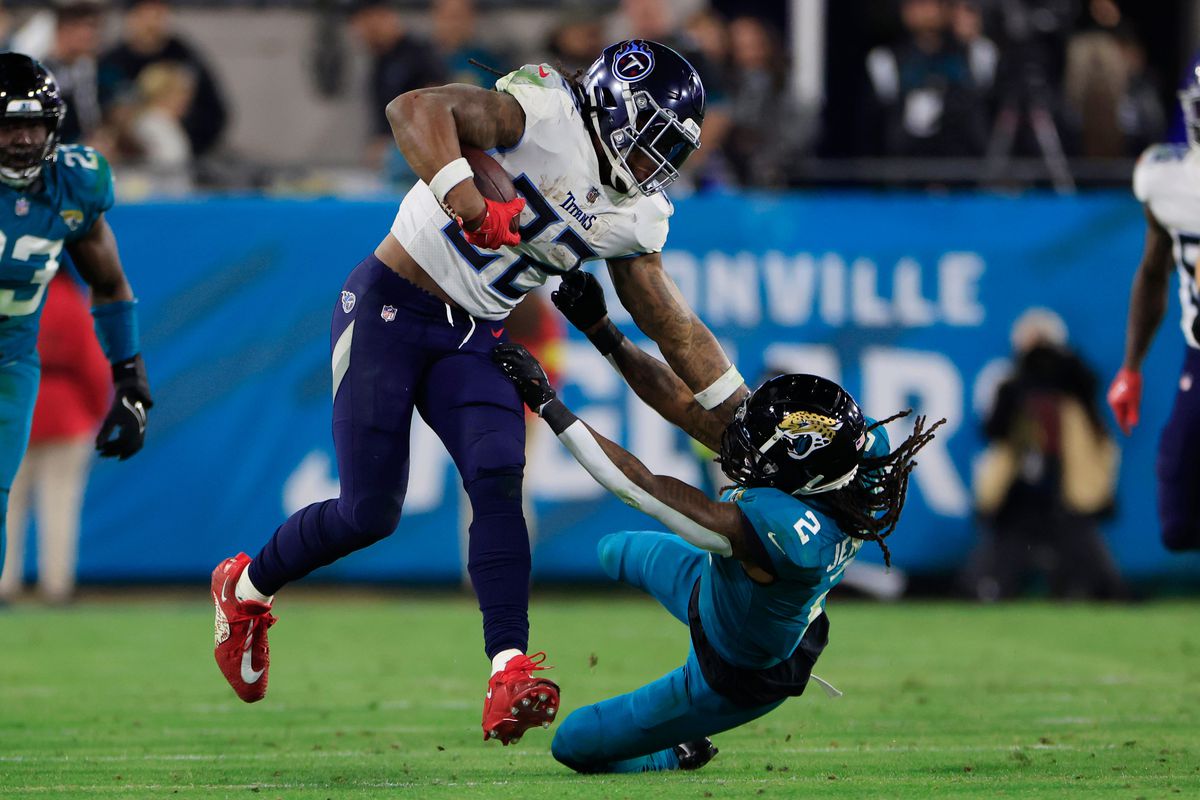 Tennessee Titans running back Derrick Henry (22) stiff arms Jacksonville Jaguars safety Rayshawn Jenkins (2) during the third quarter of an NFL football regular season matchup