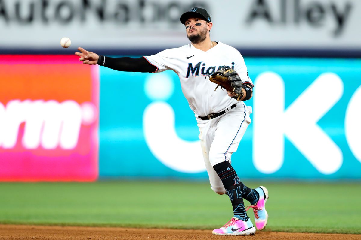 Miguel Rojas #11 of the Miami Marlins throws to first base during the eighth inning against the Atlanta Braves at loanDepot park on October 03, 2022 in Miami, Florida.