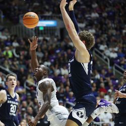 Weber State Wildcats guard Koby McEwen (15) drives on Brigham Young Cougars forward Caleb Lohner (33) in Ogden on Saturday, Dec. 18, 2021. BYU won 89-71.