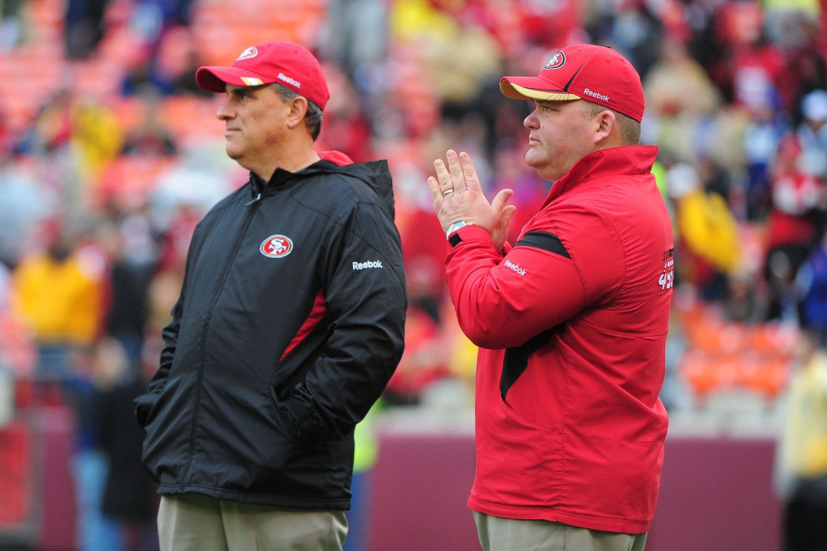 Jan 22, 2012; San Francisco, CA, USA; San Francisco 49ers defensive coordinator Vic Fangio (left) and offensive coordinator Greg Roman (right) watch warm ups before the 2011 NFC Championship game against the New York Giants at Candlestick Park.