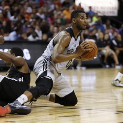 San Antonio Spurs’ Brandon Davies passes against the Phoenix Suns during the second half of an NBA summer league basketball game Monday, July 20, 2015, in Las Vegas. (AP Photo/John Locher)