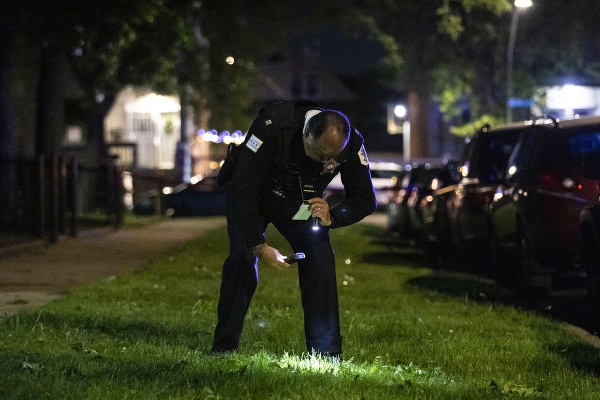 Chicago police investigate in the 3700 block of West McLean Avenue in Logan Square, where authorities said a 29-year-old man was shot multiple times Saturday night.