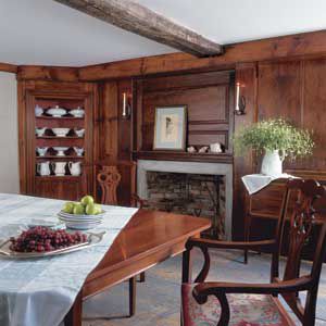 <p>With its wide-plank flooring, raised paneling, and old-wood beams, the dining room looks as though it has barely been touched by time, much less gutted by fire.</p>