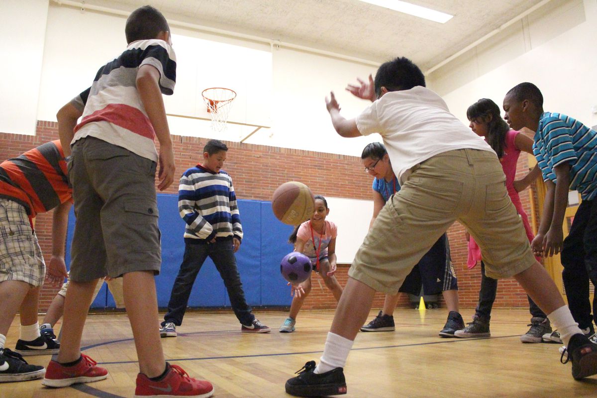 Students practiced their goalie skills by standing in a circle and trying to stop the balls from passing between their feet. This activity was offered by YMCA.