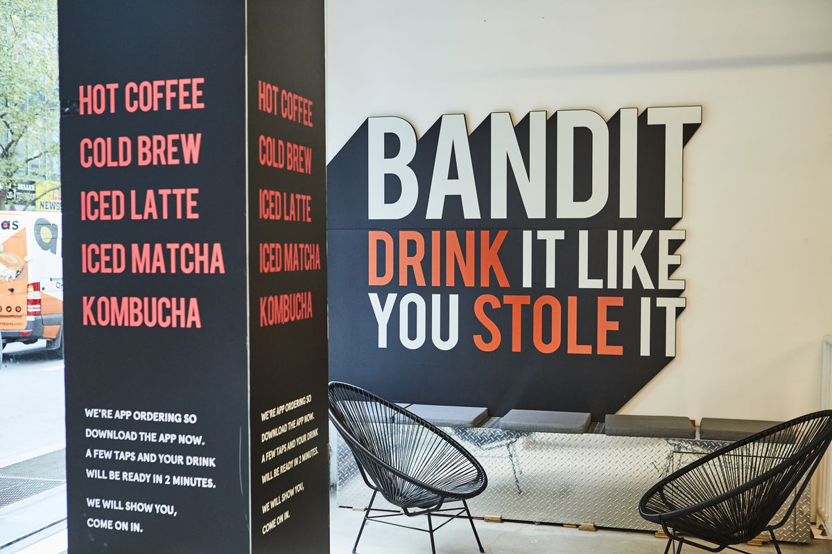 A pole displays names of coffees, while a poster on the back says “Bandit, drink it like you stole it”