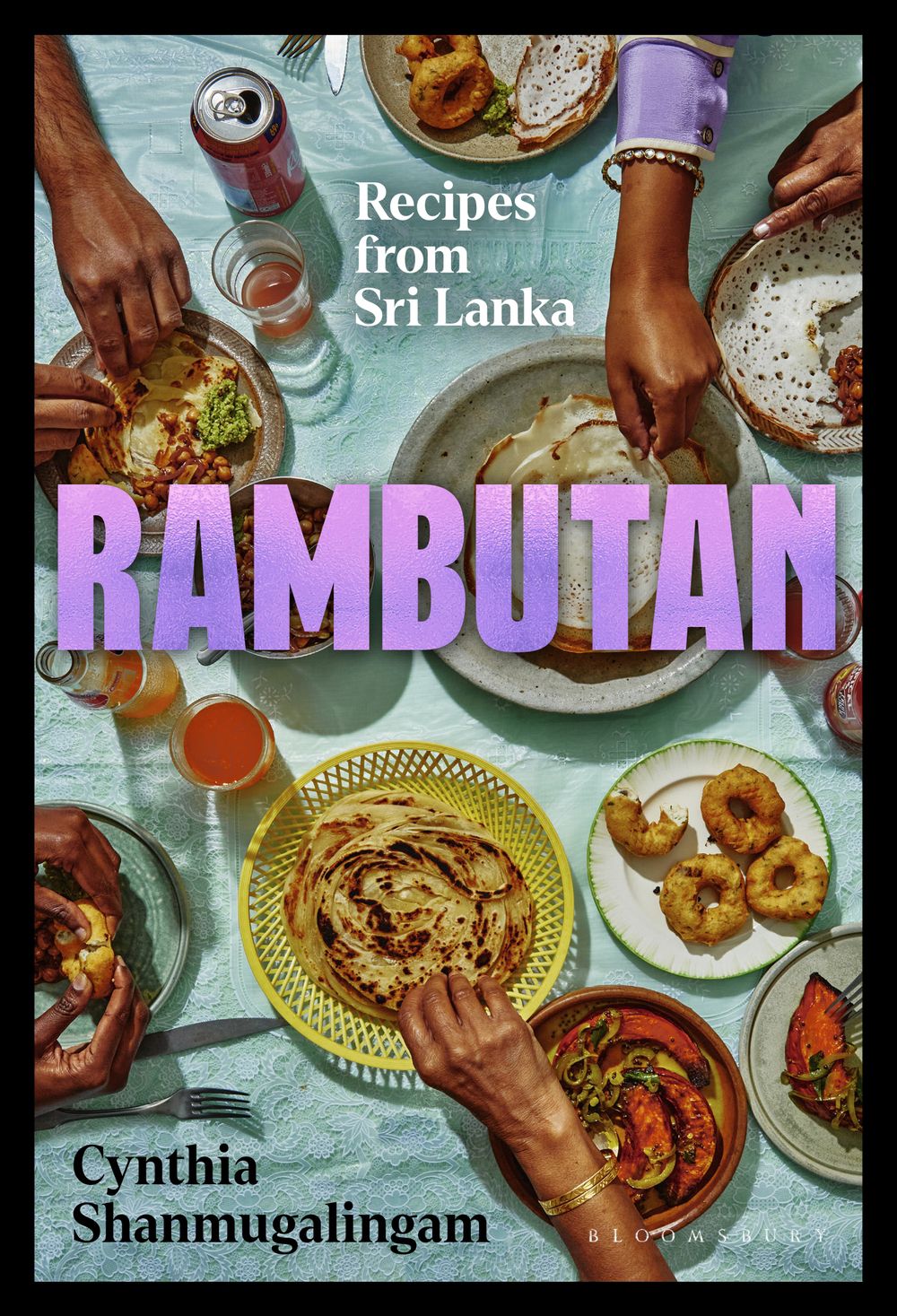 The cover of “Rambutan” featuring a plate of roti and other Sri Lankan dishes