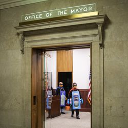 Mayor Lori Lightfoot and Dr. Allison Arwady, commissioner of the Chicago Department of Public Health, wear “Rona Destroyer” costumes and walk through City Hall to a press conference about Halloween in Chicago, Thursday afternoon, Oct. 1, 2020.