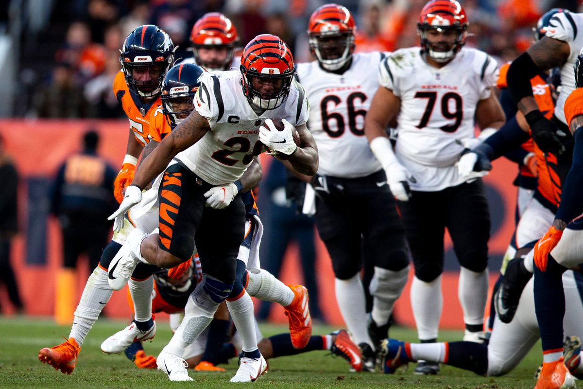 Denver Broncos safety Kareem Jackson (22) tackles Cincinnati Bengals running back Joe Mixon (28) in the second half of the NFL football game on Sunday, Dec. 19, 2021, at Empower Field in Denver.