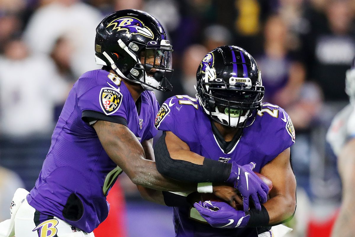 Lamar Jackson looks to hand off to Mark Ingram II of the Baltimore Ravens during the first half against the Tennessee Titans in the AFC Divisional Playoff game at M&amp;T Bank Stadium on January 11, 2020 in Baltimore, Maryland.