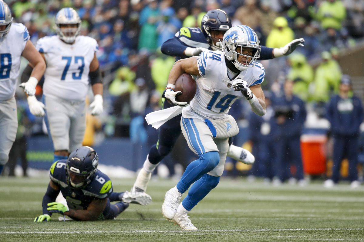 Detroit Lions wide receiver Amon-Ra St. Brown (14) rushes for a touchdown against the Seattle Seahawks during the second quarter at Lumen Field.