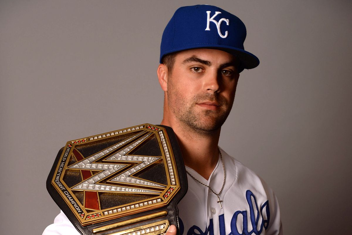 Kansas City Royals second baseman Whit Merrifield (15) poses for a photo with the WWE World Heavyweight Championship during media day at Surprise Stadium. Mandatory Credit: Joe Camporeale