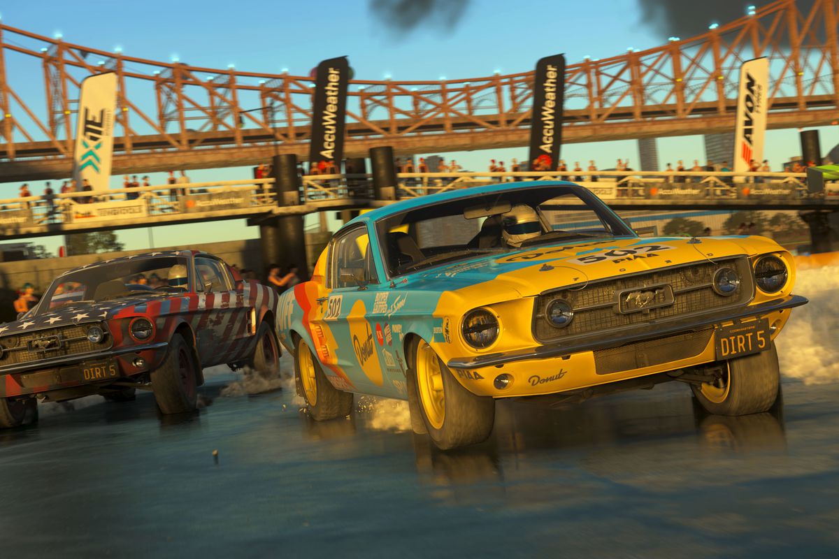 Two muscle cars race in a screenshot from Dirt 5