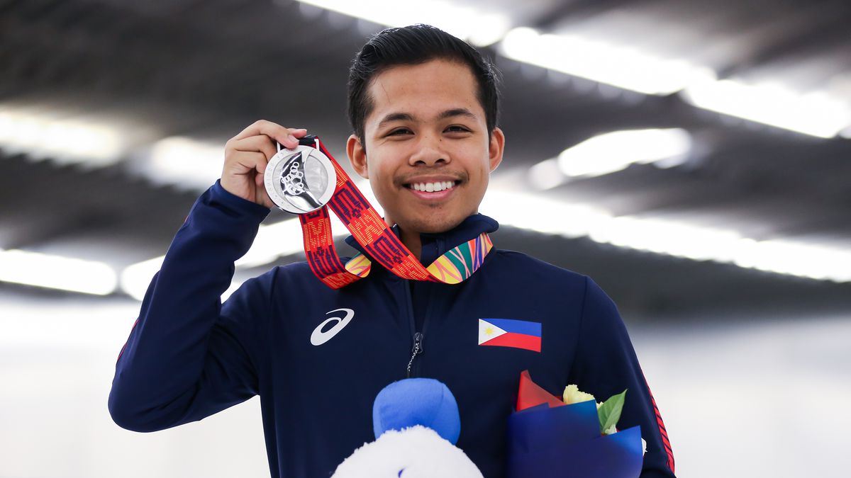 Christopher Caluza of the Philippines poses with his silver medal for figure skating at the Southeast Asian Games in 2019 in Manila.
