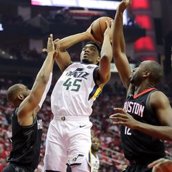 Utah Jazz guard Donovan Mitchell (45) is fouled by Houston Rockets guard Chris Paul (3) as he goes up for a shot as the Utah Jazz and the Houston Rockets play game two of the NBA playoffs at the Toyota Center in Houston on Wednesday, May 2, 2018.