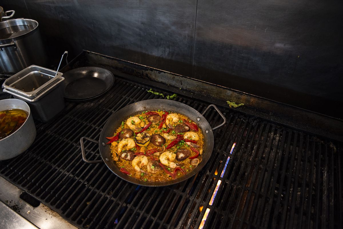 A pan of paella on top of a stove.