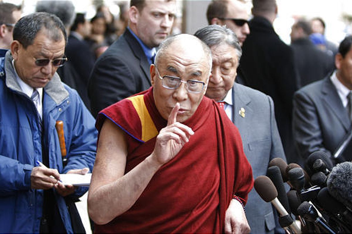 The Dalai Lama gestures while speaking to reporters outside his hotel in Washington Thursday.