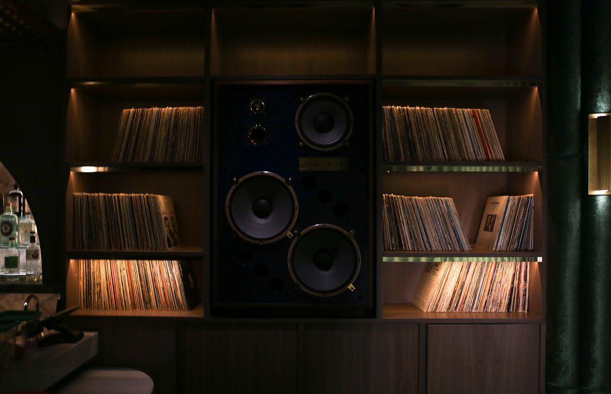 Speakers surrounded by records.